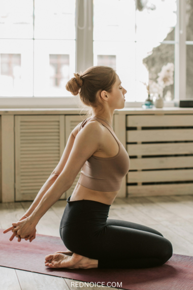 A bright, airy photo of a person performing a morning stretch on a yoga mat. PT-recommended routine to relieve stiffness and improve daily mobility.