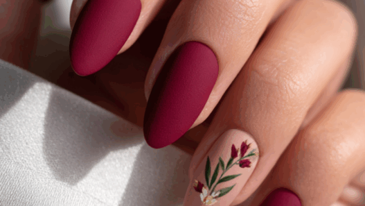 Rich maroon almond nails finished with a soft, velvety matte topcoat for a luxurious warm winter texture.