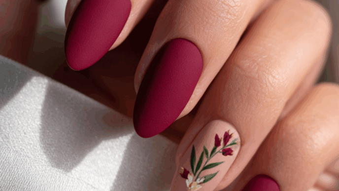 Rich maroon almond nails finished with a soft, velvety matte topcoat for a luxurious warm winter texture.